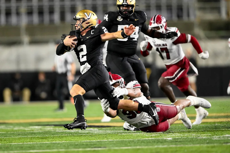 Nov 9, 2024; Nashville, Tennessee, USA; Vanderbilt Commodores quarterback Diego Pavia (2) breaks the tackle of South Carolina Gamecocks defensive tackle T.J. Sanders (90) during the second half at FirstBank Stadium. Mandatory Credit: Steve Roberts-Imagn Images