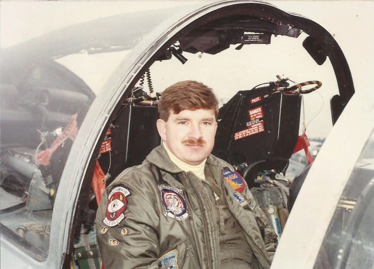 Harve Smith seated inside of a jet plane outside