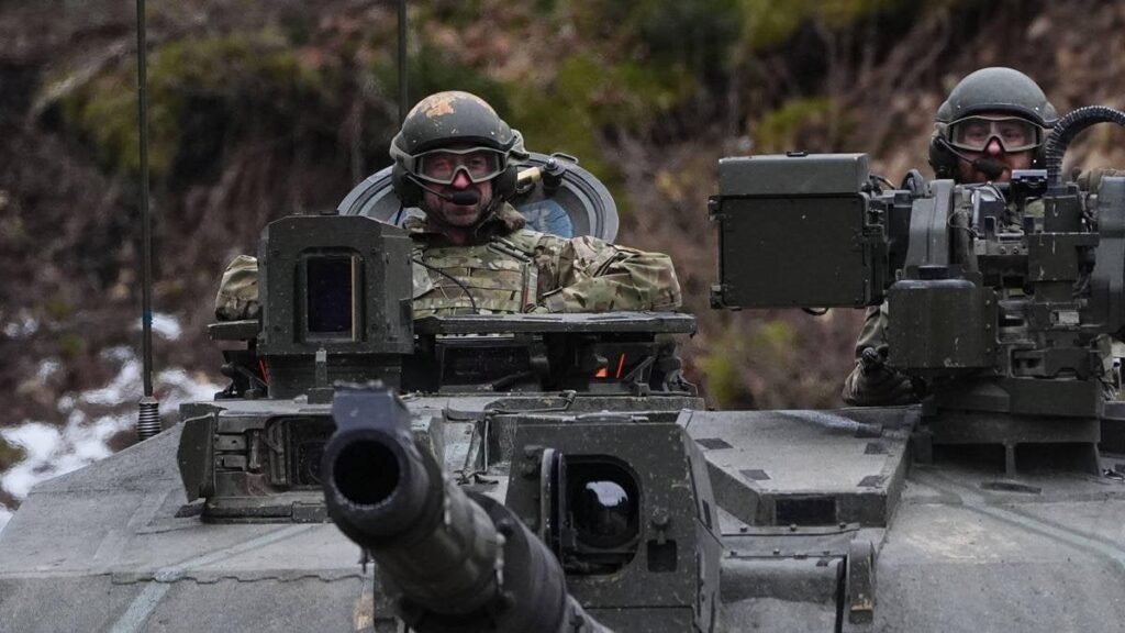 Prince William rides in tank on NATO's border with Russia as he gives British troops show of support
