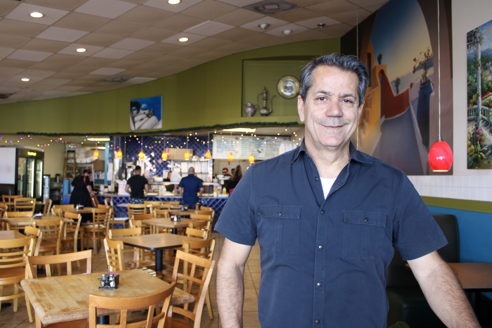 Zorba Greek Restaurant transforms Round Rock into Greece with traditional cuisine An image of the owner of the restaurant inside the location.