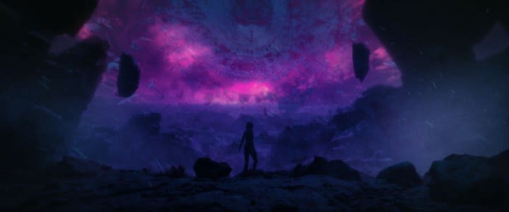 An astronaut stands on a planet and looks up.