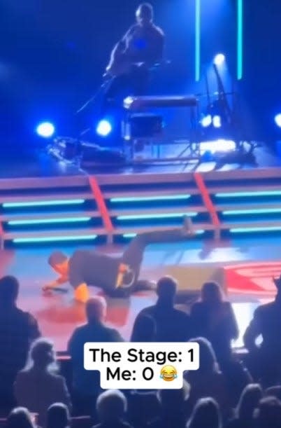 scotty mccreery on the ground after falling on stage