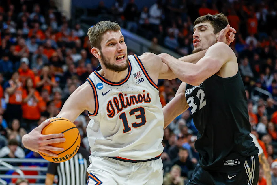Illinois center Tomislav Ivisic (13) drives against Xavier forward Zach Freemantle (32) in the first round of the NCAA college basketball tournament Friday, March 21, 2025, in Milwaukee. (AP Photo/Jeffrey Phelps)