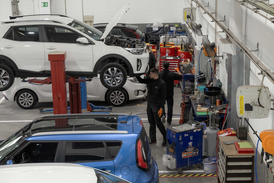 Mechanics examine Kia cars at Kia Integral Car, a dealership in Barcelona, Spain. [KIA]