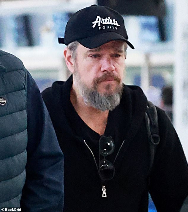 The American actor looked unrecognisable with a long grey beard and moustache as he arrived at the airport