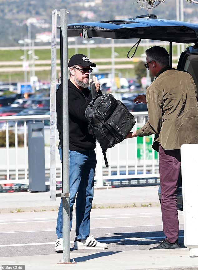 The Hollywood action star collected his bag from the taxi driver, happy to carry his own luggage