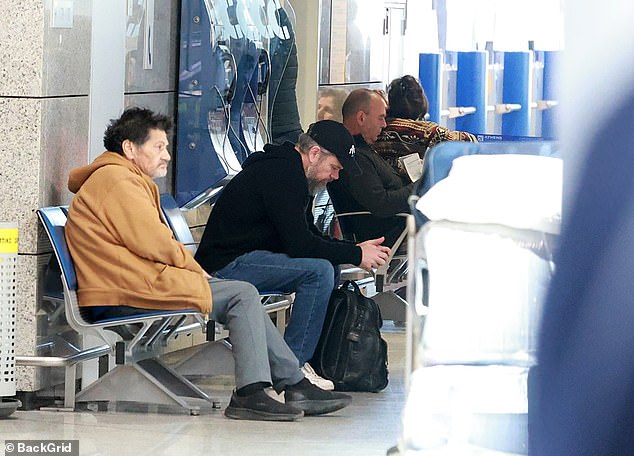 Matt was seen taking a seat, going unrecognisable among fellow passengers at the airport