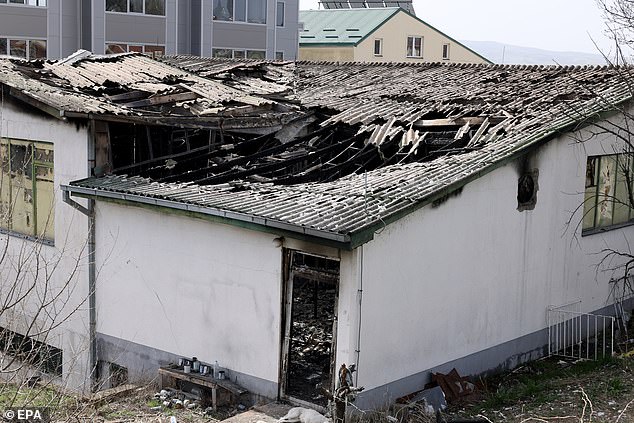 An exterior view of the club after the fire, with a huge hole visible in the centre of the roof where the fire damage was at its most severe