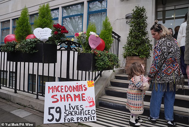 The entrance to the North Macedonian embassy in London, which features a sign reading 'Macedonia's shame: 59 lives sacrificed for profit' and a red handprint