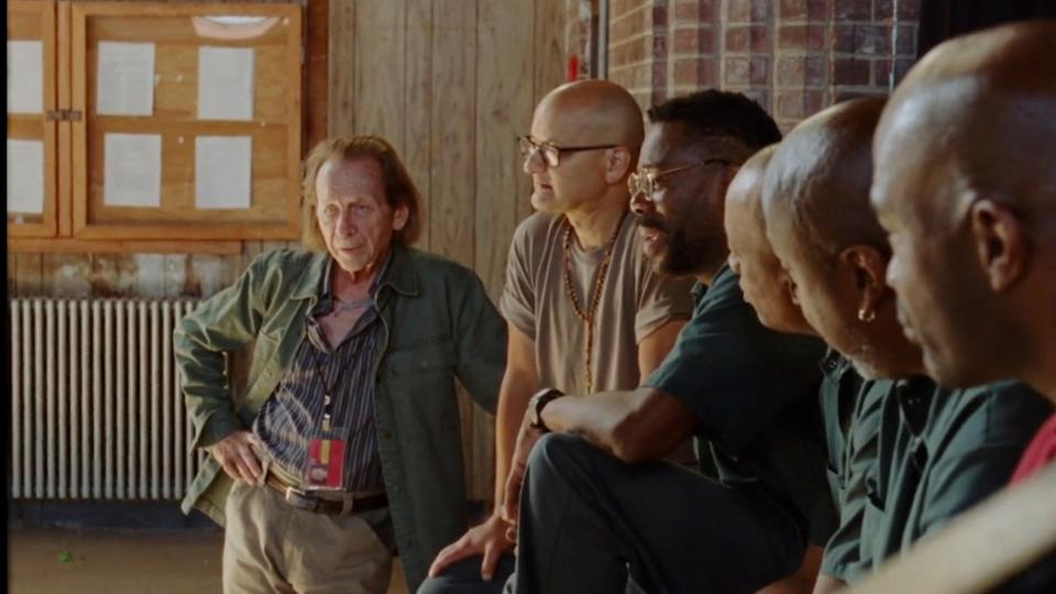 Paul Raci, Colman Domingo, and Sean San Jose looking talking in Sing Sing. 