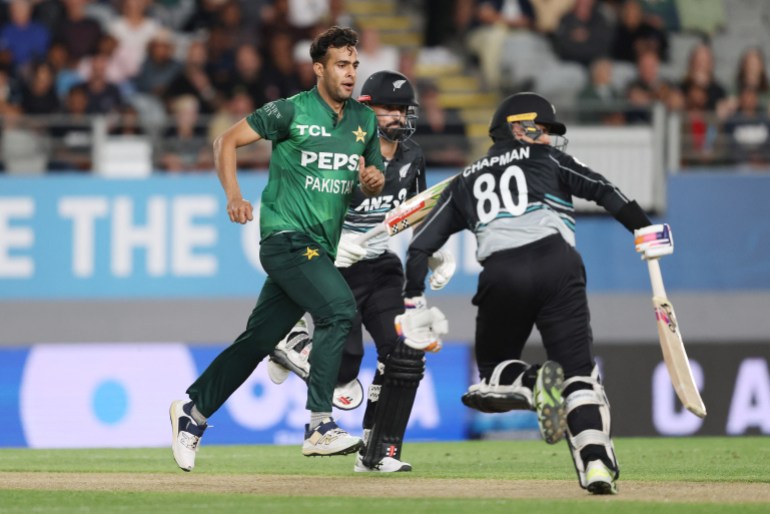 Pakistan's Abbas Afridi (L) chases the ball between New Zealands players Daryl Mitchell (C) and Mark Chapman (R) during the third T20 international cricket match between New Zealand and Pakistan at Eden Park in Auckland on March 21, 2025. (Photo by Michael Bradley / AFP)