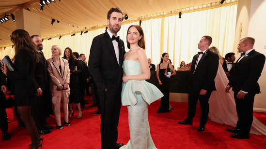 Emma Stone and Dave McCary pose on the red carpet during the Oscars arrivals at the 96th Academy Awards in Los Angeles. (REUTERS)