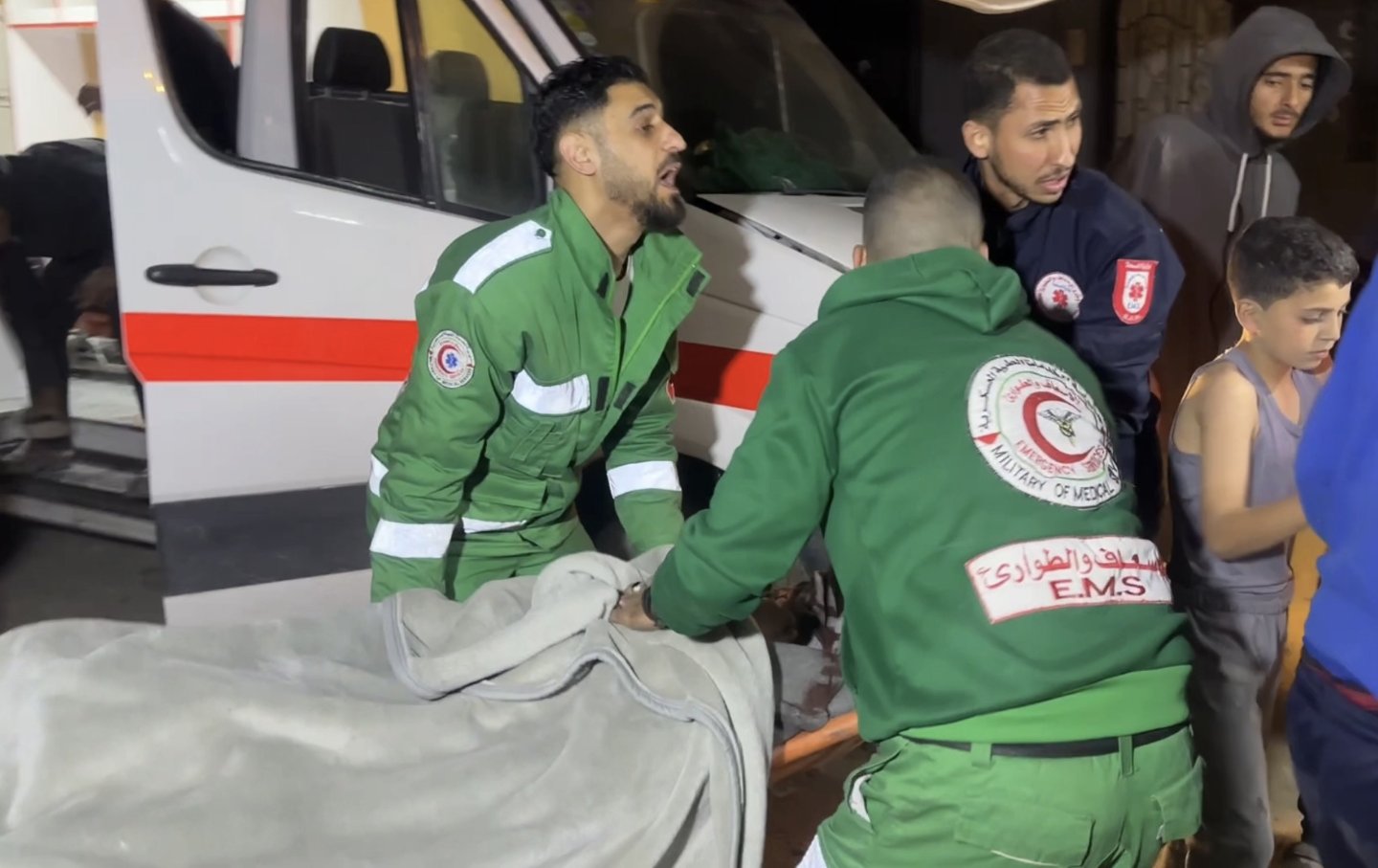 Civil defense and medical teams respond to an Israeli attack on the At-Tabeen School in Gaza City on March 18, 2025.