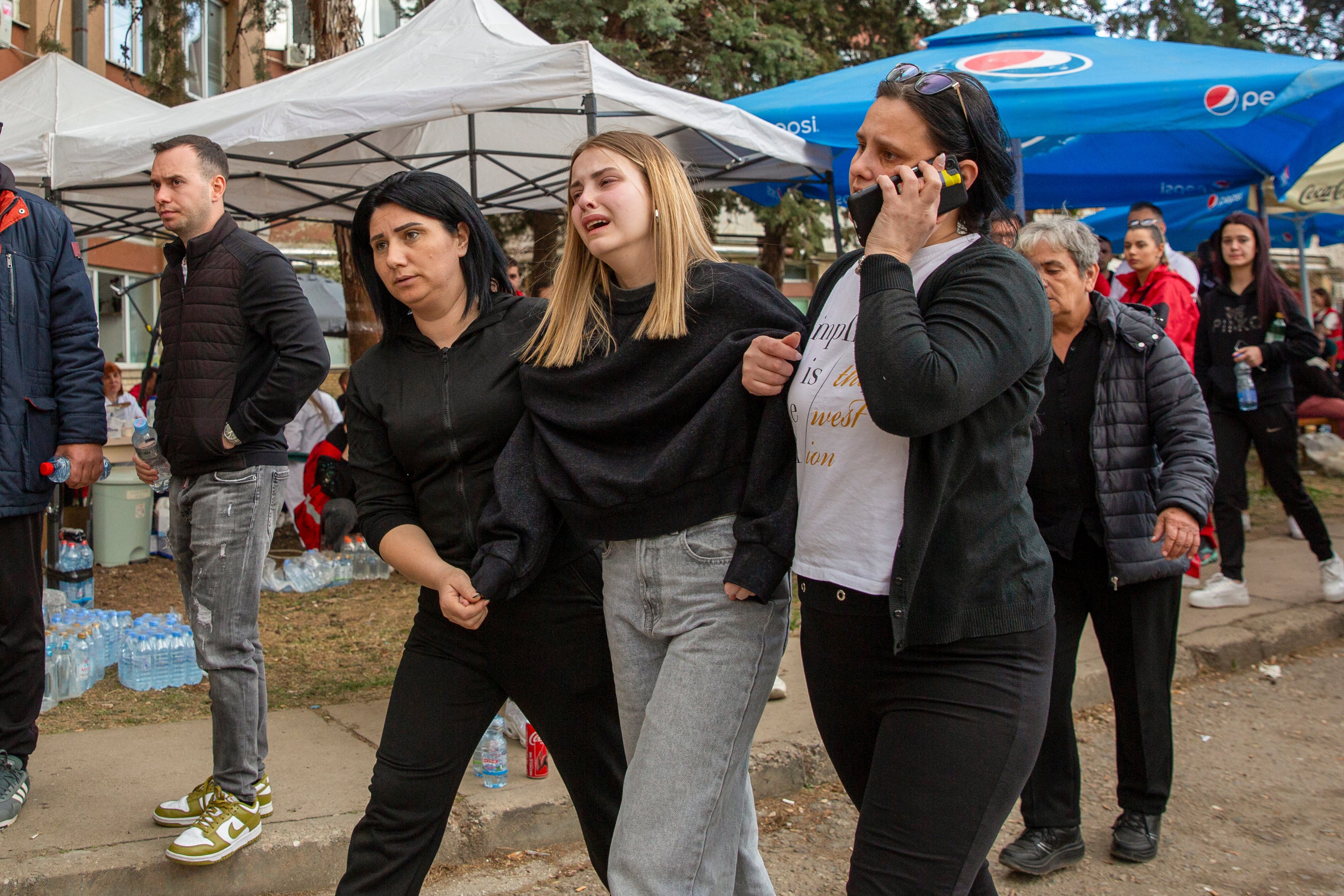 Relatives and survivors outside a hospital in the town of Kocani