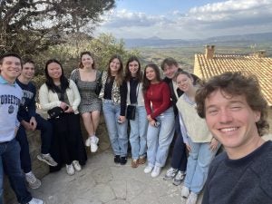 A selfie of students overlooking some plains and mountains in Spain