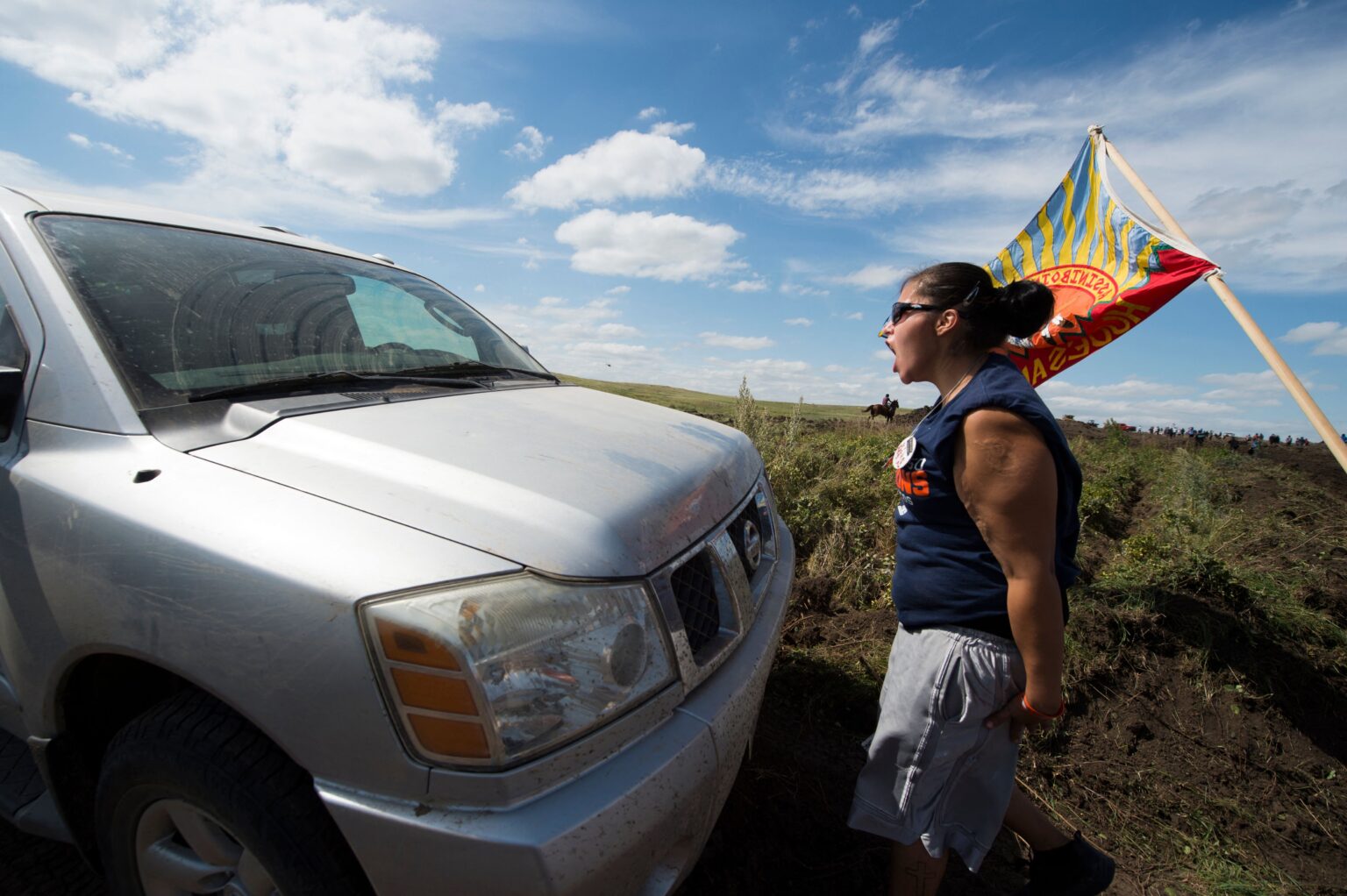 A Native American protestor confronts a private security contractor at a work site for the Dakota Access Pipeline, near Cannon Ball, North Dakota, in September 2016. Credit: Robyn Beck/AFP via Getty Images