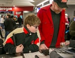 Hank Vogel, left, and his father Jon Vogel check out a OneCourt tactile device before a Portland Trail Blazers game on Feb. 22, 2025. The Portland Trail Blazers are the first professional sports team to offer this device at all of their home games. 