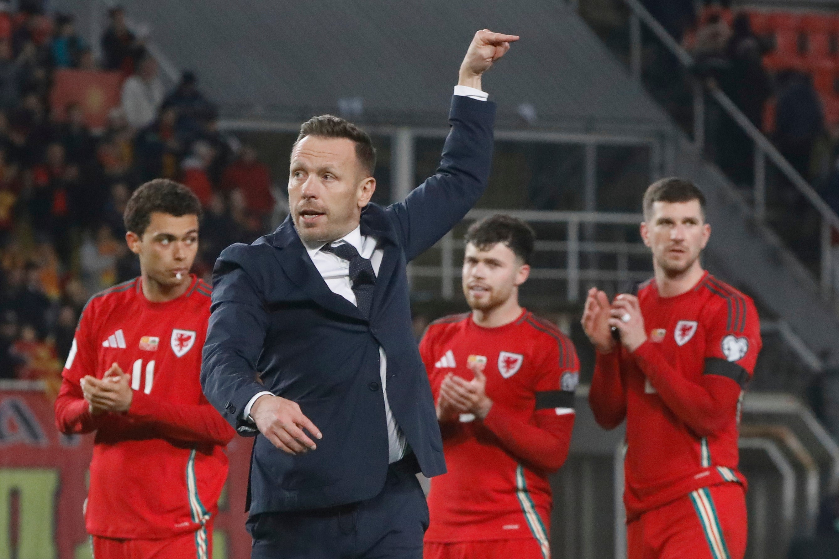 Wales' head coach Craig Bellamy acknowledges the fans after drawing with North Macedonia