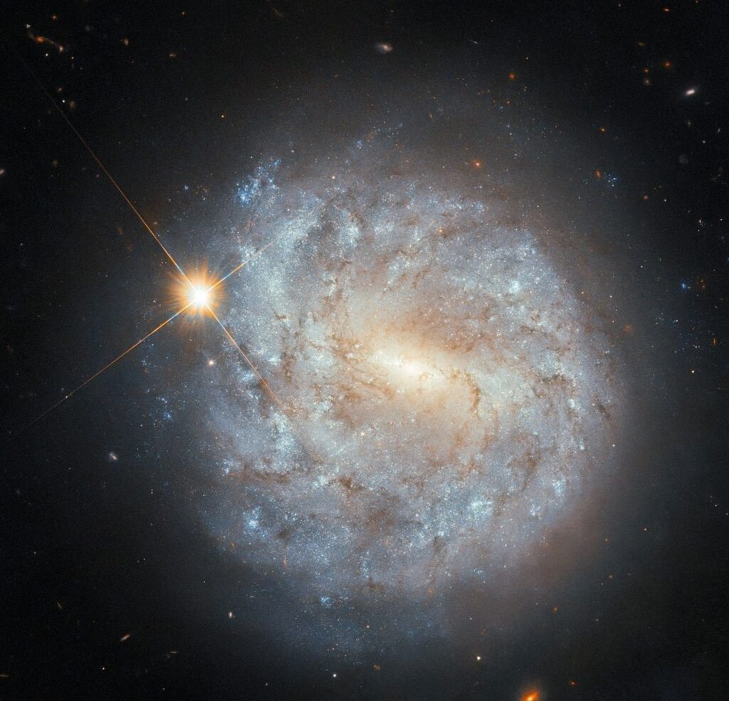Hubble Sees a Spiral and a Star.