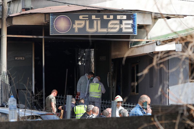 Rescue crews operate outside a night club, following a fire resulting in casualties, in the town of Kocani