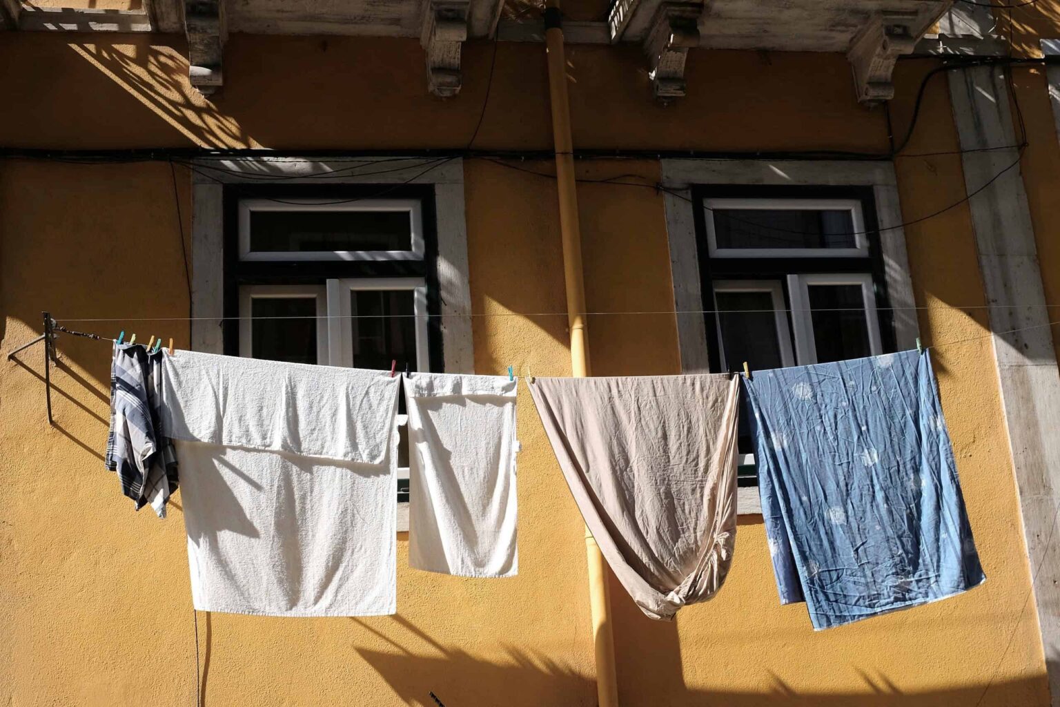 Your Clothes Dryer Is Costing You (and the Environment) More Than You Think clothes on a drying rack
