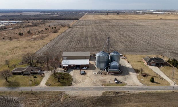 The homes of brothers Don and Dan Roberts bookend their Minooka family farm, March 19, 2025. A large data center is proposed for the land directly behind their homes and business, while a water pipeline is planned out front across Wildy Road. (Brian Cassella/Chicago Tribune)