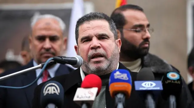 Salah al-Bardaweel speaking into a number of microphones on 15 February 2015 in Gaza city
