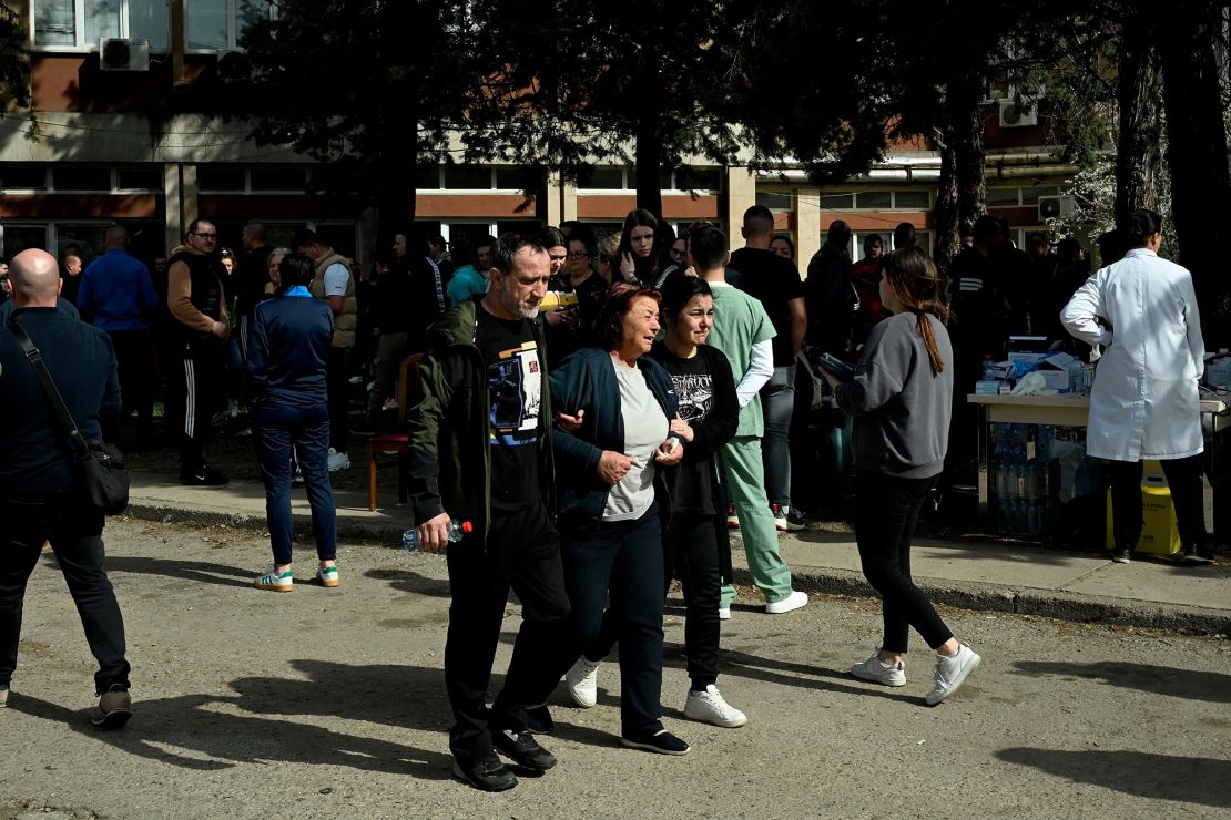 Friends and relatives of the victims gather in front of a hospital following the fire.