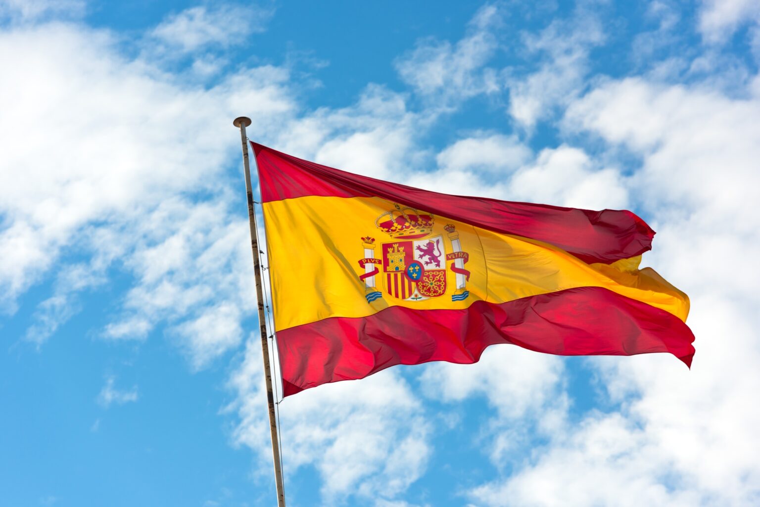 Multiverse Computing Announces a $70 Million Investment From The Spanish government National Flag of Spain on blue sky background