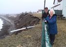 Stan Peach of Glace Bay stands with his mother Joyce Peach in her backyard in Port Morien that overlooks a 50-foot cliff. Stan estimates over the years 75 feet of land has been lost to erosion and says he worries about his mother who is living only 15 feet from the cliff edge. Sharon Montgomery-Dupe/Cape Breton Post  - Sharon Montgomery-Dupe