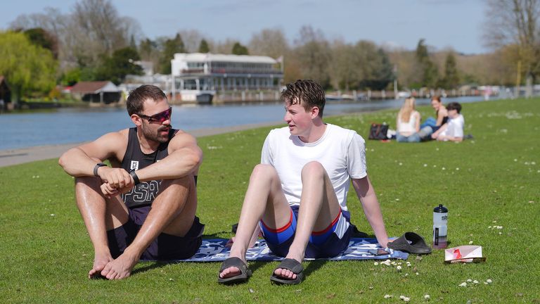Tom Brumwell (left) and Byron Richards enjoy the good weather beside the River Thames in Henley-on-Thames, Oxfordshire.  
Pic: PA