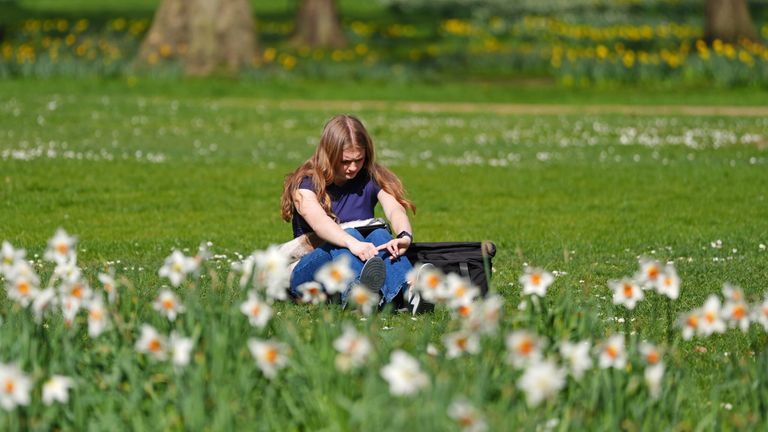 A woman sitting in Green Park, central London, during a spell of warm weather. Picture date: Friday March 28, 2025, 2025. PA Photo. Photo credit should read: Ben Whitley/PA Wire