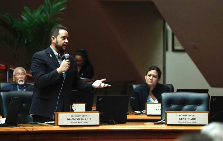 JAMM AQUINO / JAQUINO@STARADVERTISER.COM
                                Rep. Gene Wards seat inside the House chambers is seen empty, at right, as Rep. Diamond Garcia speaks during sessions, today, in Honolulu. Ward has retired after 27 years due to health issues.
