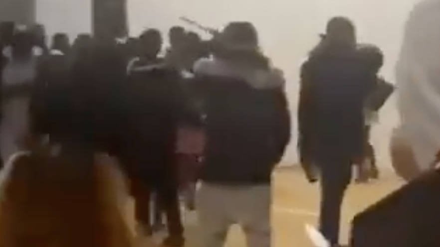 Terrifying moment gang of 'knife-wielding thugs storm primary school party, stabbing two'