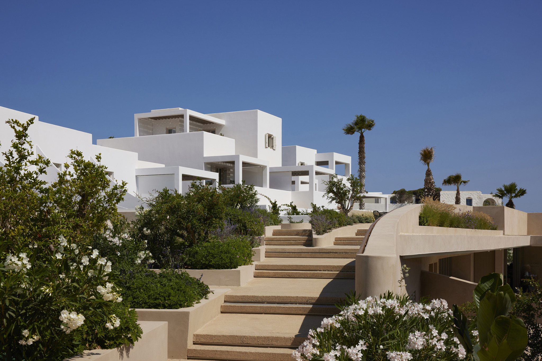Avant Mar Hotel in Paris, showcasing its white architecture and landscaping.