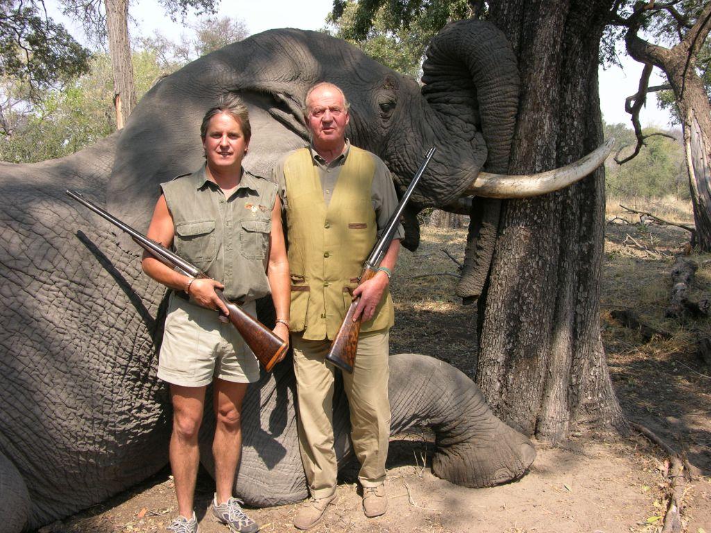King Juan Carlos of Spain and another man posing with rifles next to a dead elephant in Botswana.