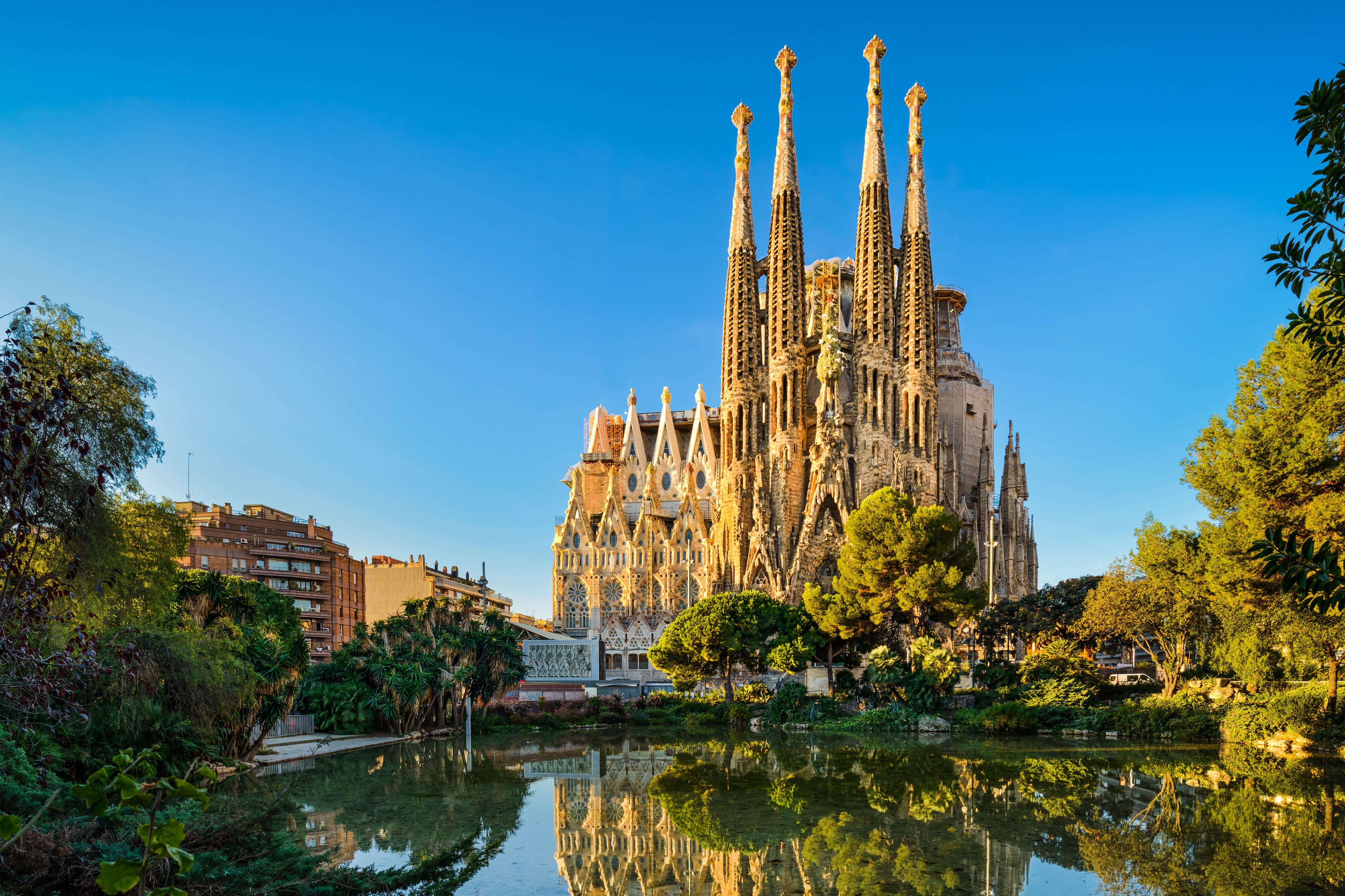 Sagrada Familia cathedral in Barcelona reflected in a pond.