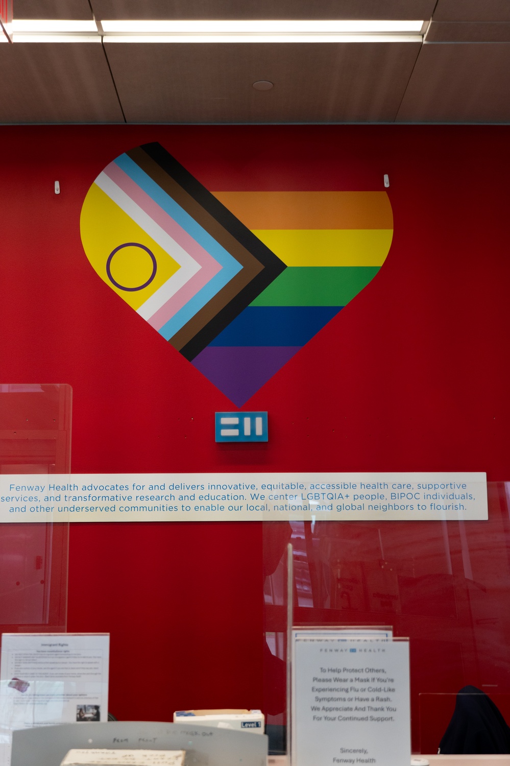 A wall in Fenway Health's building, decorated with their mission statement.