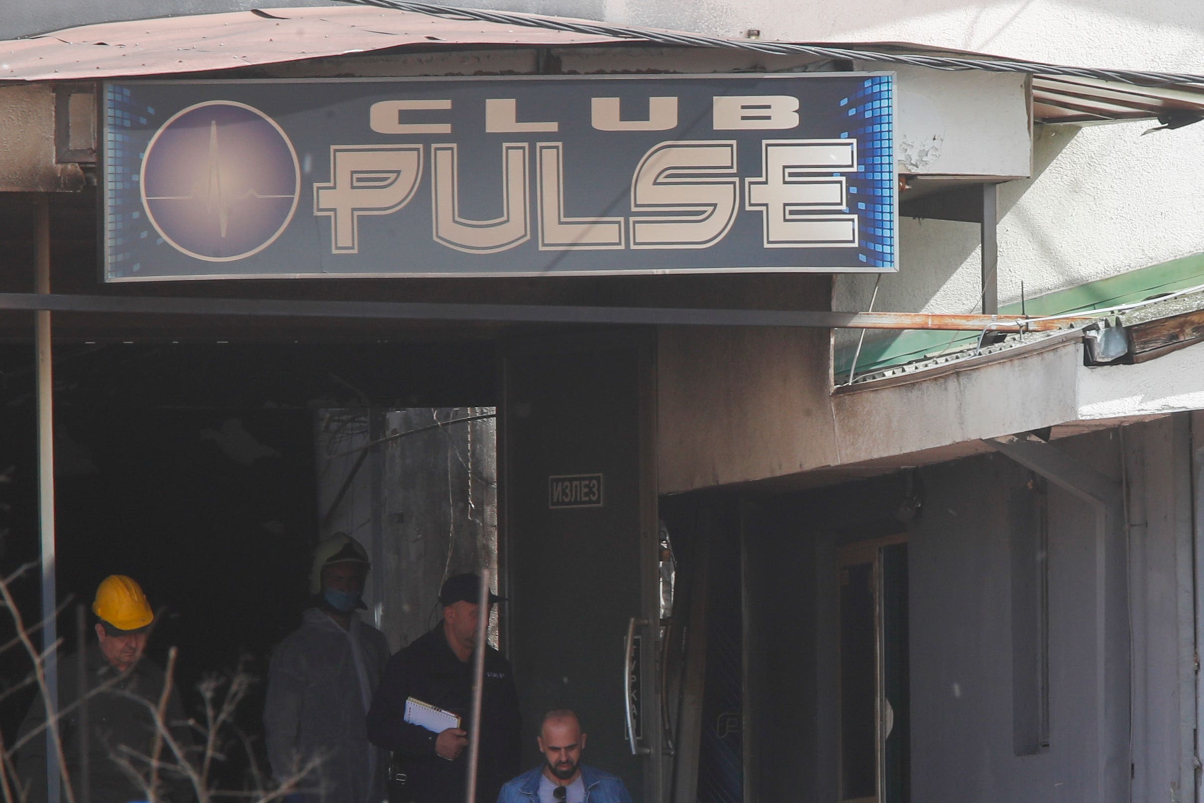 Police officers investigate a nightclub after the massive fire in the town of Kocani, North Macedonia (AP photo)