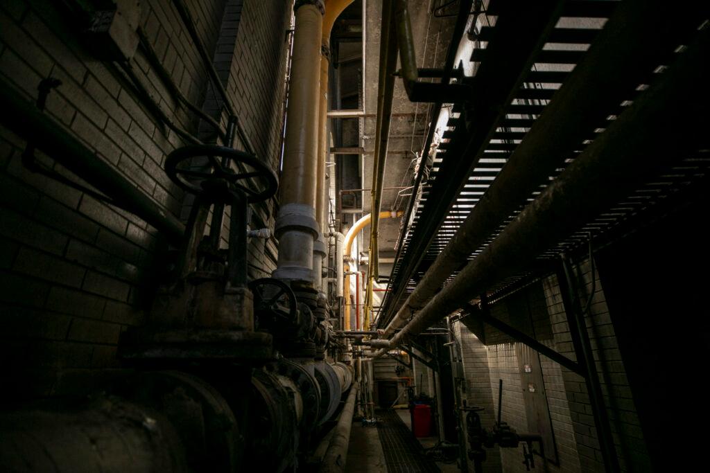 A dark, shadowy shot of equipment inside an old city-owned building.