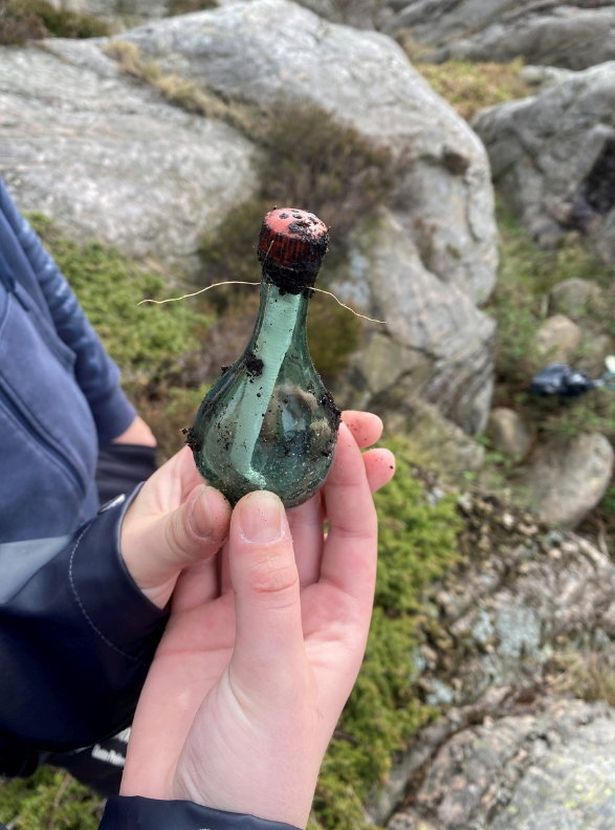 Photo shows the message as it was found in a green glass bottle