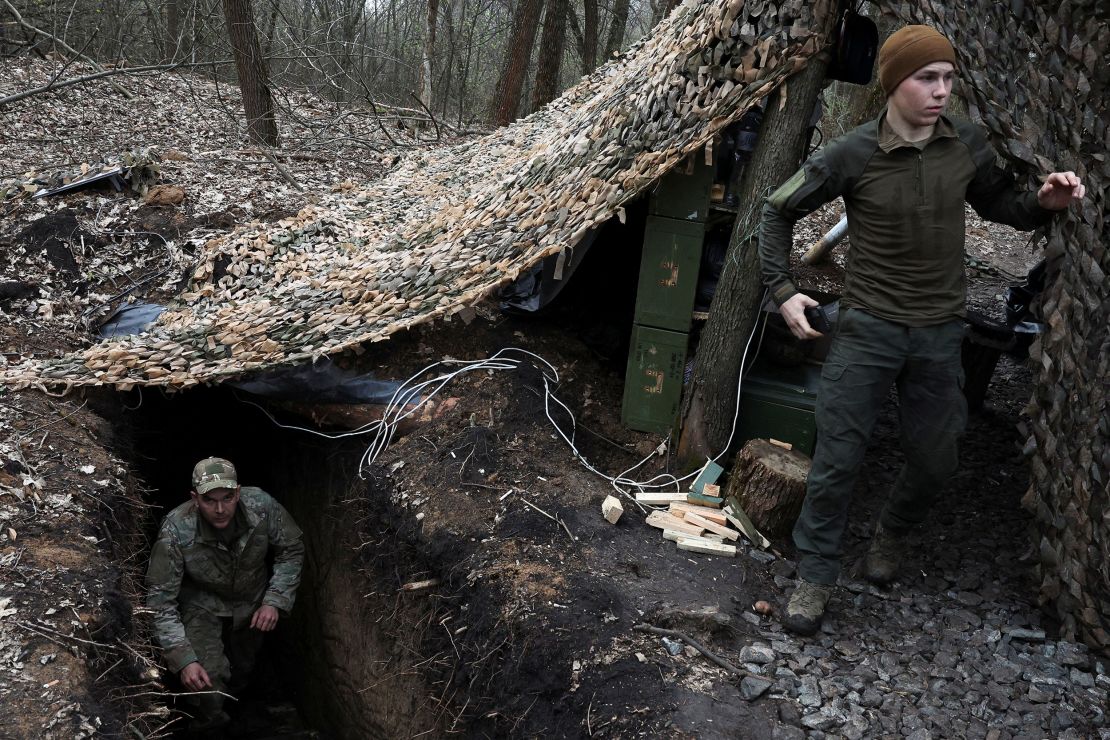 Ukrainian artillery crew members manning a howitzer position at an undisclosed location on the Donetsk frontline on April 6.