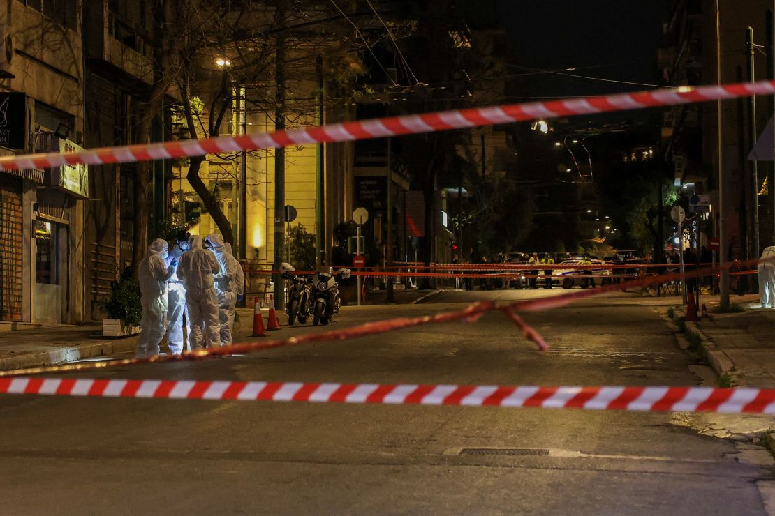 Forensics officers investigate the area of a bomb blast outside the Hellenic Train offices, in Athens, Greece, on April 11, 2025.