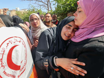 Relatives mourn during the funeral procession for members of the Palestine Red Crescent and other emergency services who were killed a week earlier by Israeli forces, at Nasser hospital in Khan Yunis in the southern Gaza Strip on March 31, 2025.