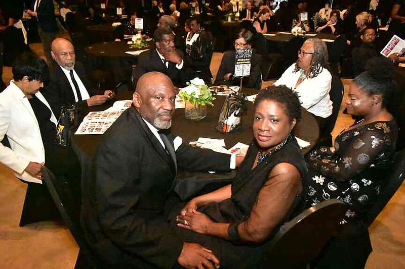 Track-and-field great Donnie Taylor and his wife Ann White-Taylor sit with family and friends. (Pine Bluff Commercial/I.C. Murrell)