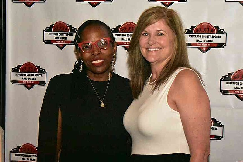 Felicia Shelton, widow of former Dollarway and Watson Chapel football coach George Shelton, and Leslie Henderson, retired Watson Chapel girls basketball and track coach, take a photo together. (Pine Bluff Commercial/I.C. Murrell)