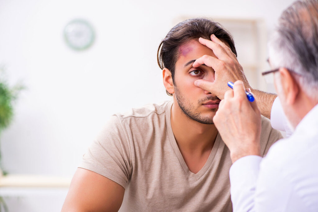 stock photo of physician holding open patient's eye and examining