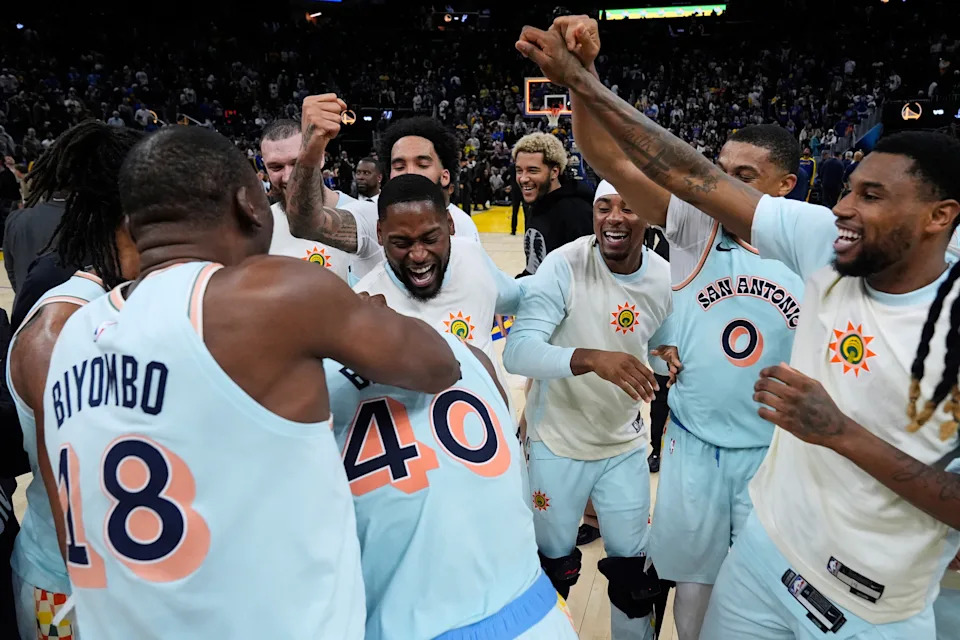 San Antonio Spurs forward Harrison Barnes (40) is congratulated by teammates after scoring the game-winning basket against the Golden State Warriors in an NBA basketball game Wednesday, April 9, 2025, in San Francisco. (AP Photo/Godofredo A. Vásquez)