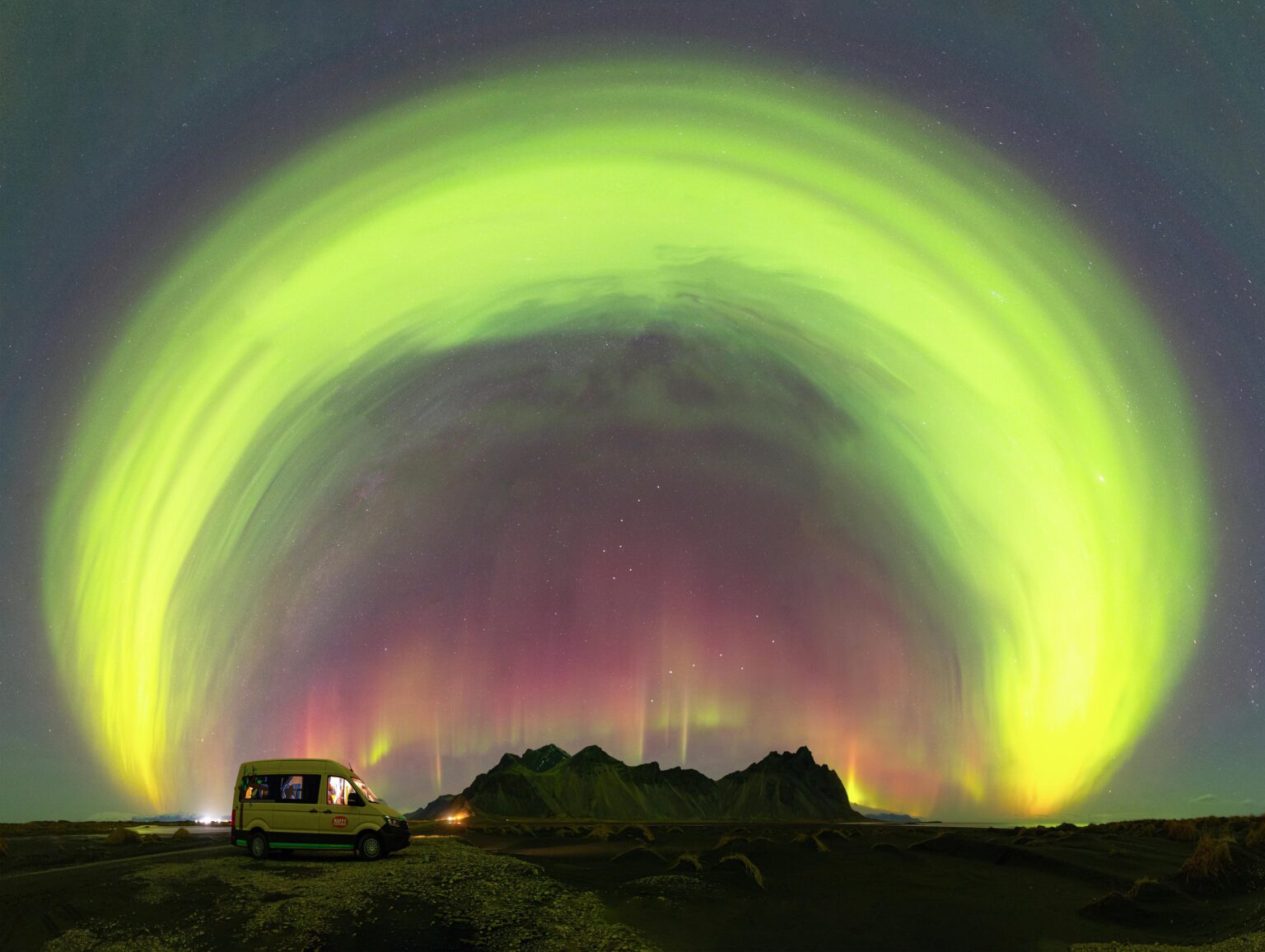 My campsite under a giant aurora arc over Vestrahorn, Iceland