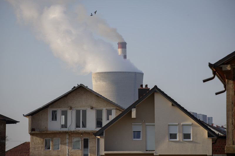 Chimneys of coal-fired power plants between houses in the town of Obilic, near the capital Pristina, Kosovo. Photo: EPA/VALDRIN XHEMAJ